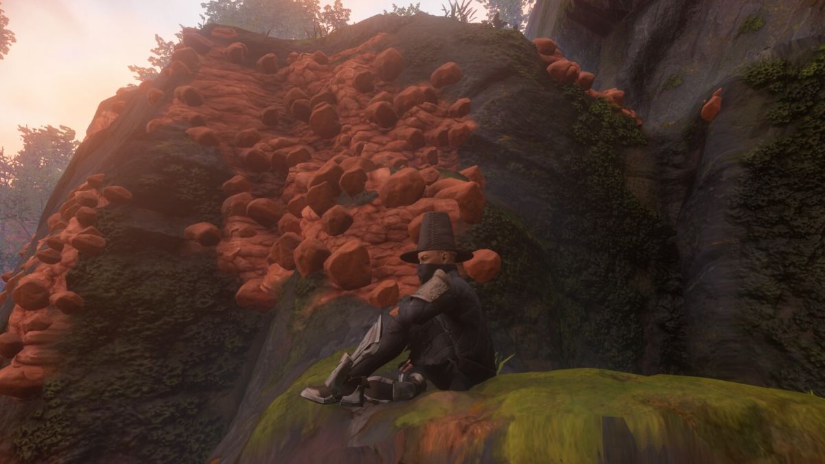 Enshrouded character sitting near clay nodes.