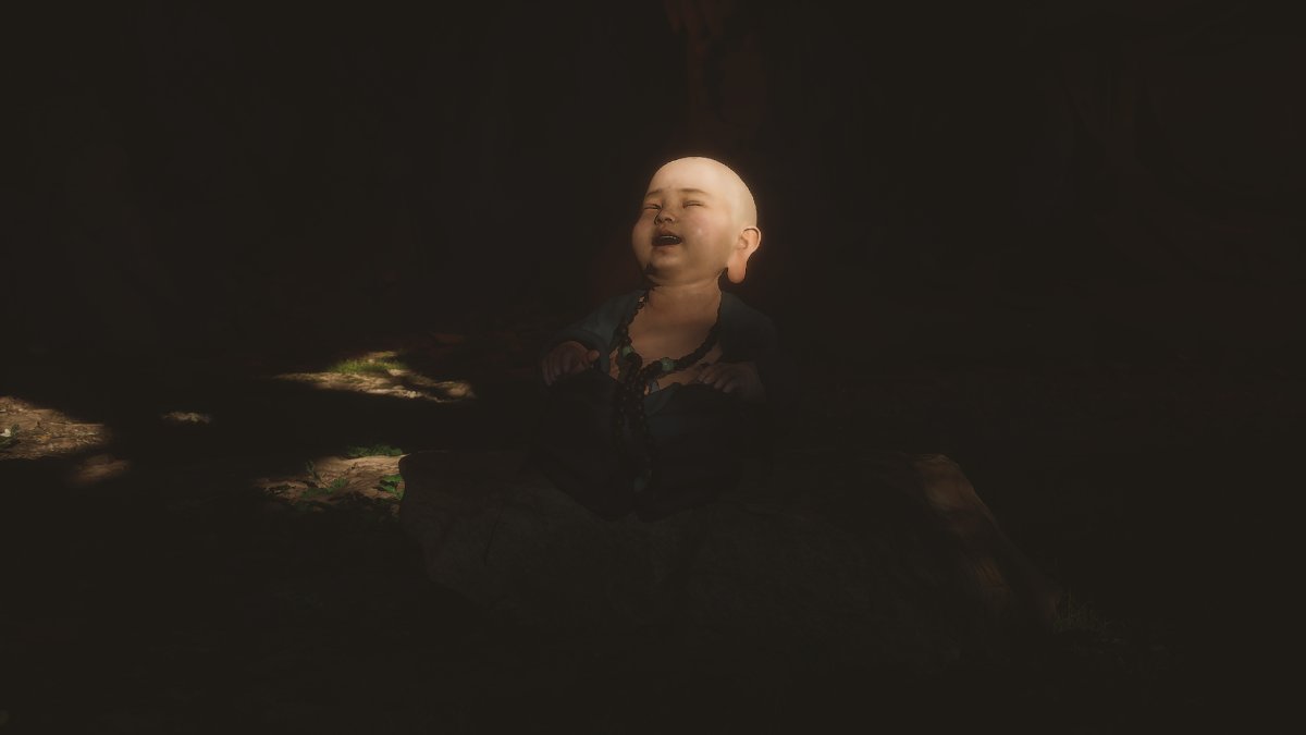 A small bald boy laughs surrounded by darkness in Black Myth: Wukong