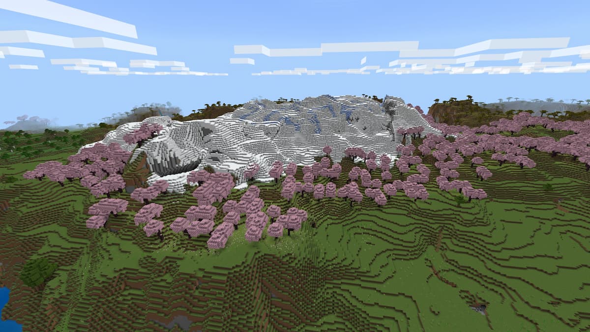 A Cherry Grove biome bordering a Snowy Slopes hill in Minecraft