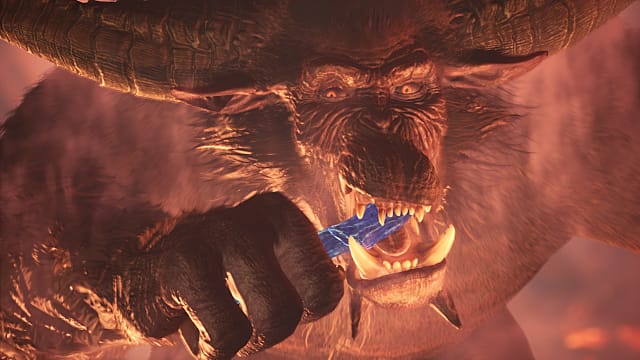 Rajang eats a bluish silver something in Monster Hunter: World Iceborne.